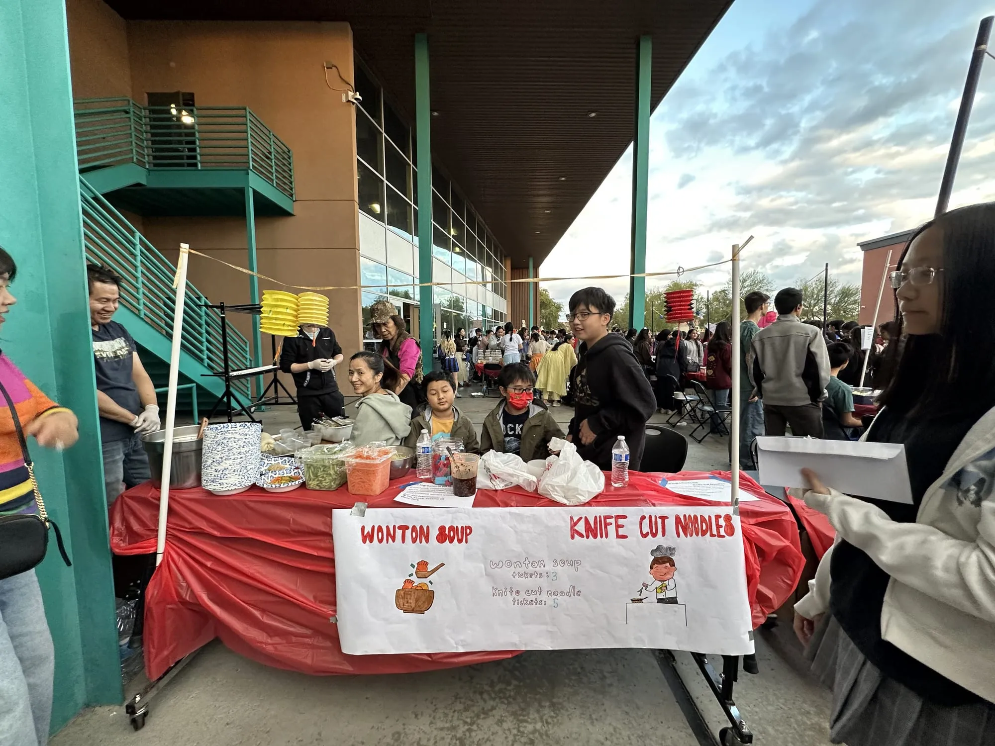 A busy booth serving wonton soup and knife-cut noodles